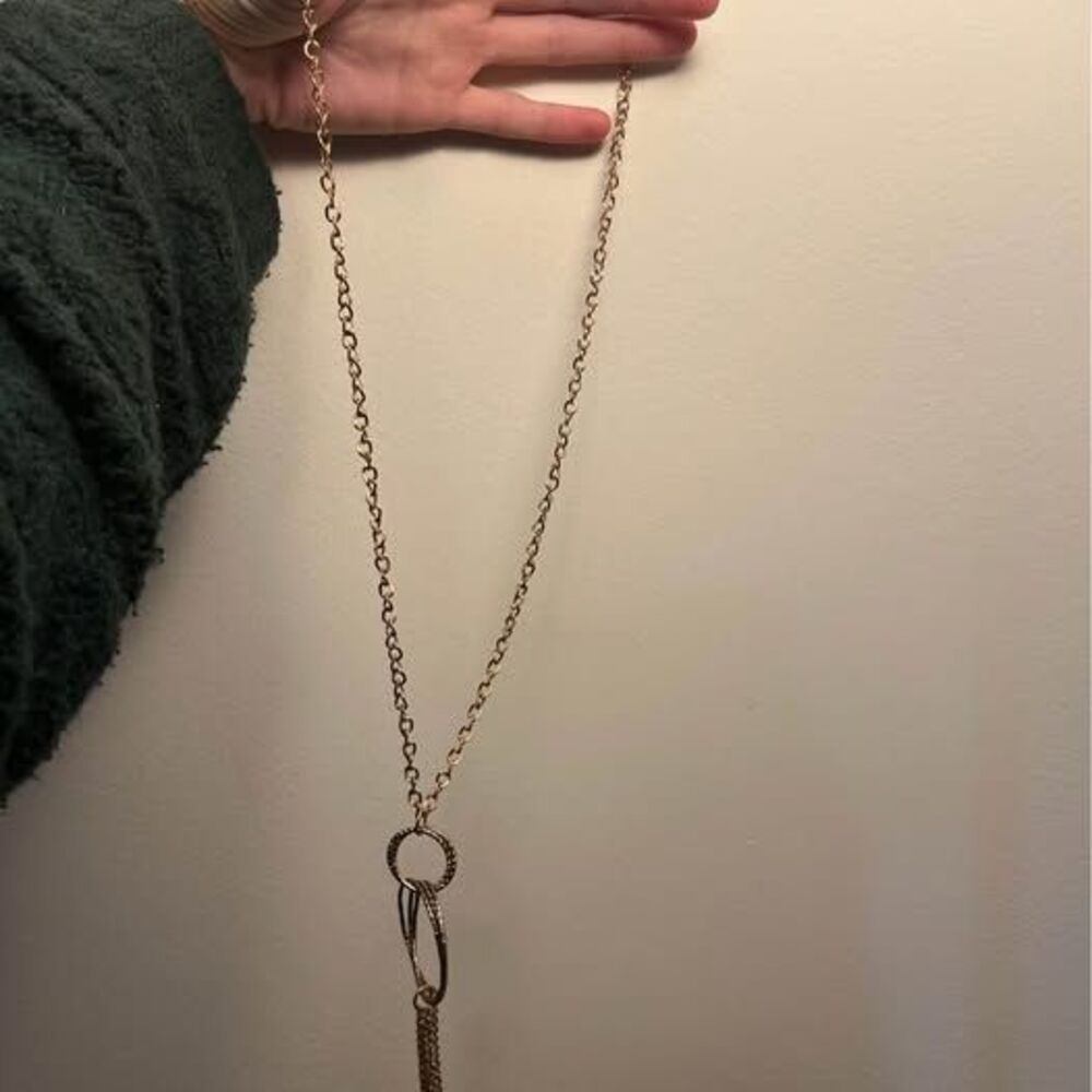 Long gold tone chain necklace with tassel pendant